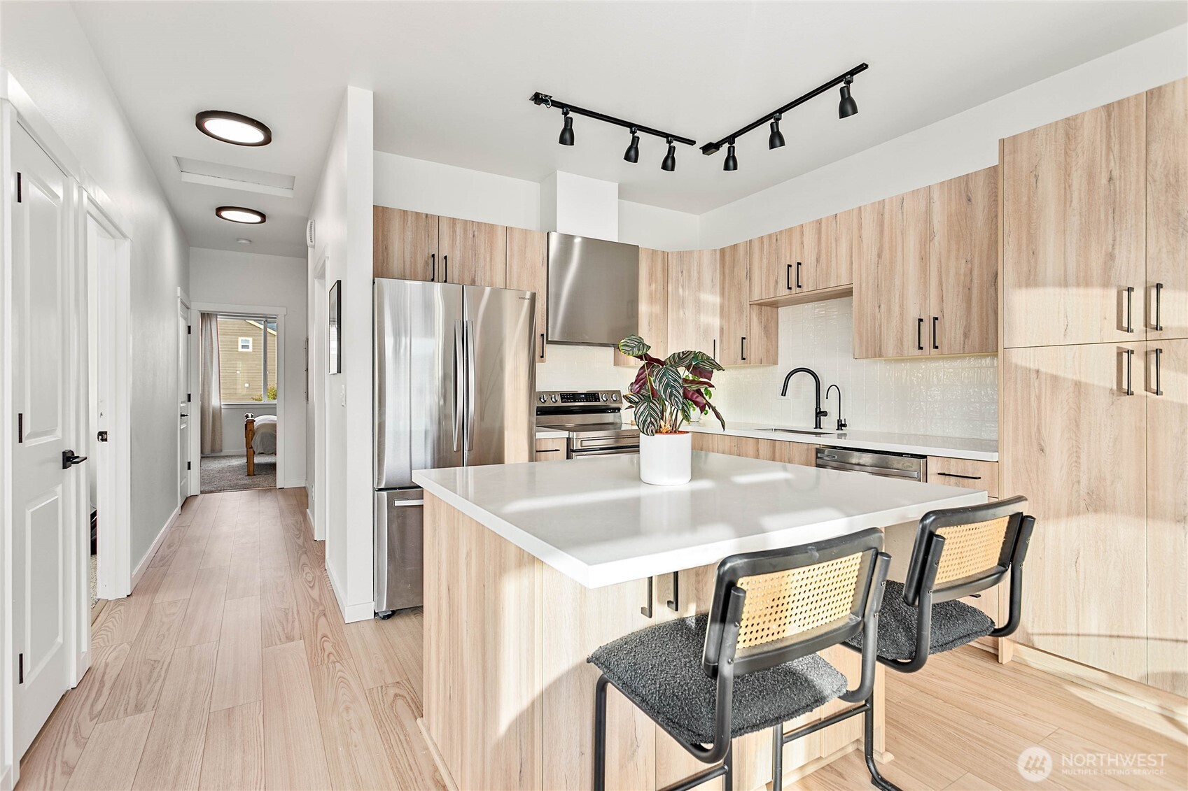 a kitchen with stainless steel appliances granite countertop a sink refrigerator and cabinets