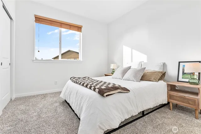 a bedroom with a bed and window