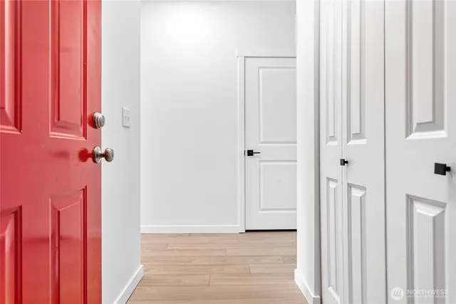 a view of a hallway with wooden floor