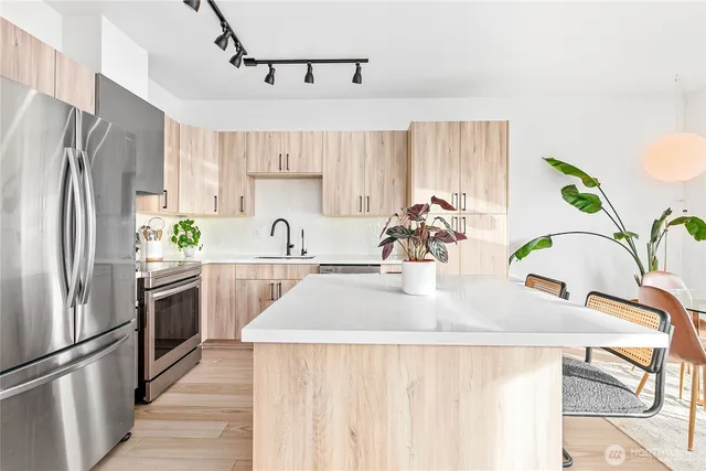 a kitchen with a sink refrigerator and microwave