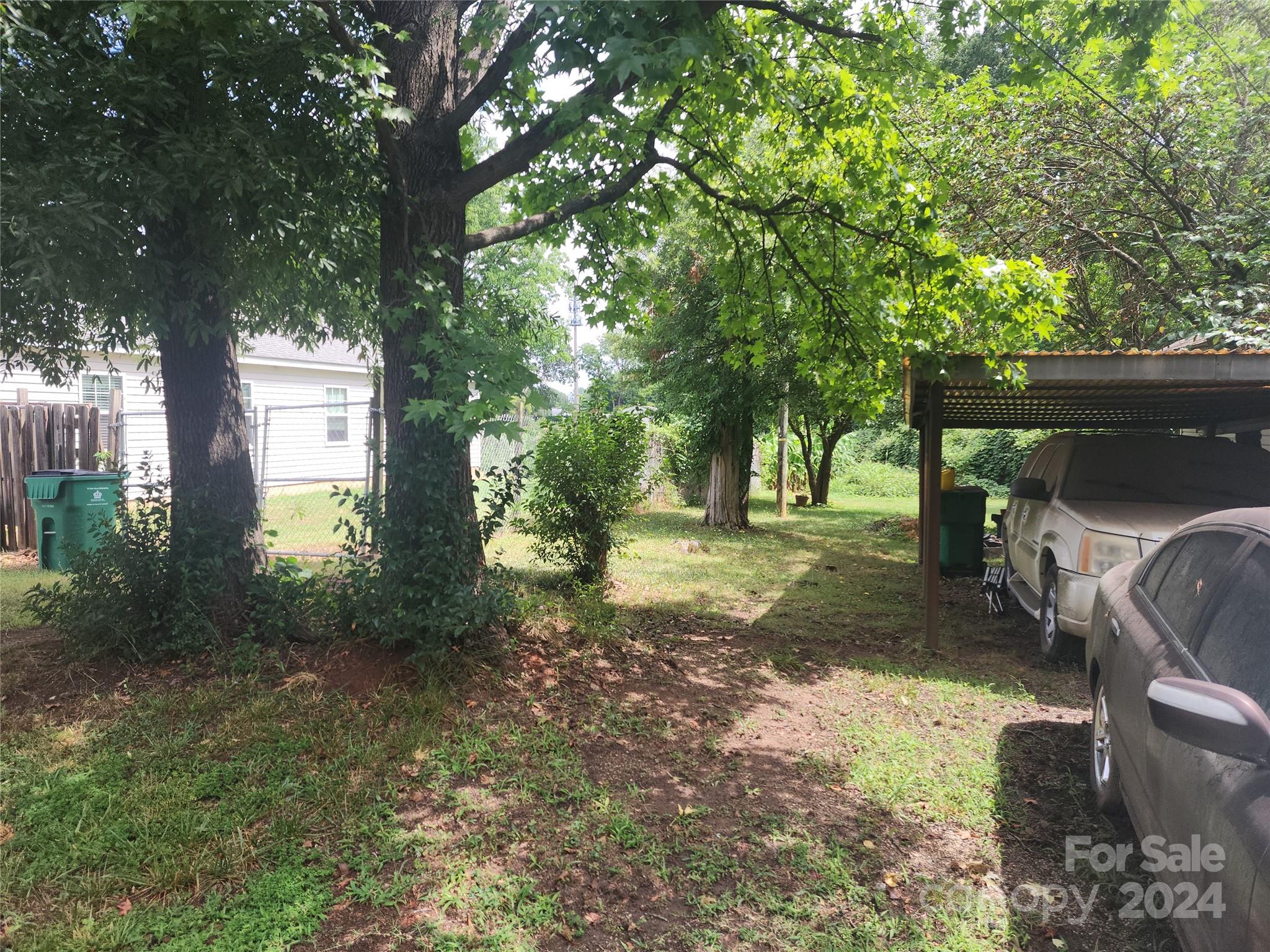 4616 Hovis Road Charlotte, NC 28208 - Photo 13 of 14 a view of a yard with plants and a large tree
