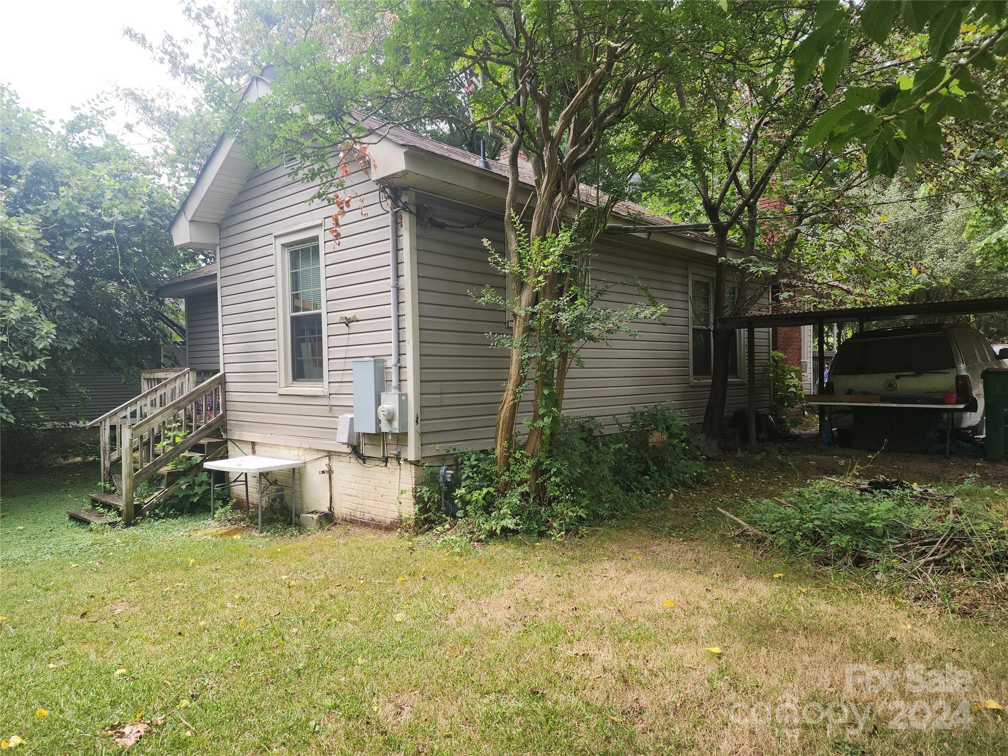 4616 Hovis Road Charlotte, NC 28208 - Photo 14 of 14 a view of a backyard with plants and large tree