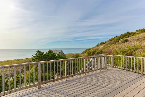 a view of a balcony with wooden floor and fence