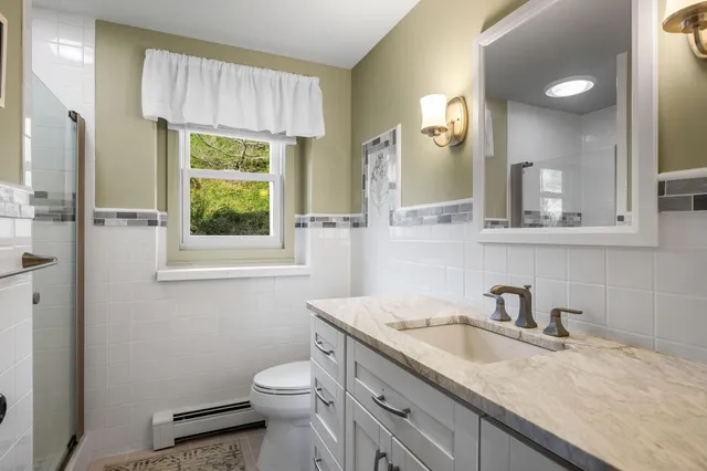 a dining room with furniture a rug and wooden floor