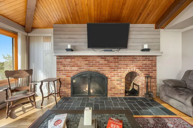 a dining room with furniture window and wooden floor