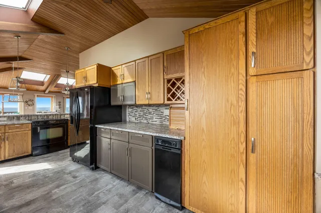 a view of balcony with wooden floor and ocean view