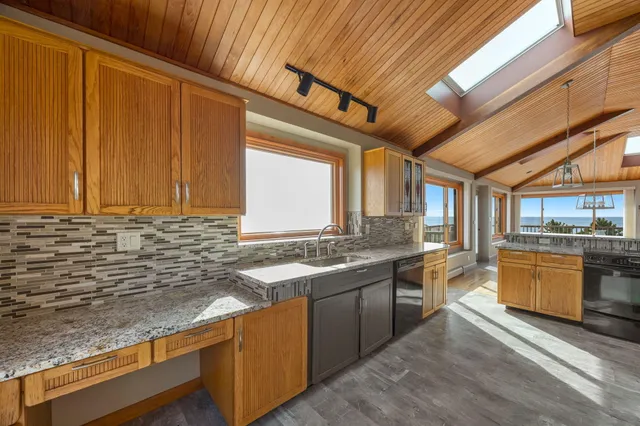 a view of house with swimming pool and seating area