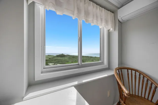 a large bed sitting in a bedroom next to a window