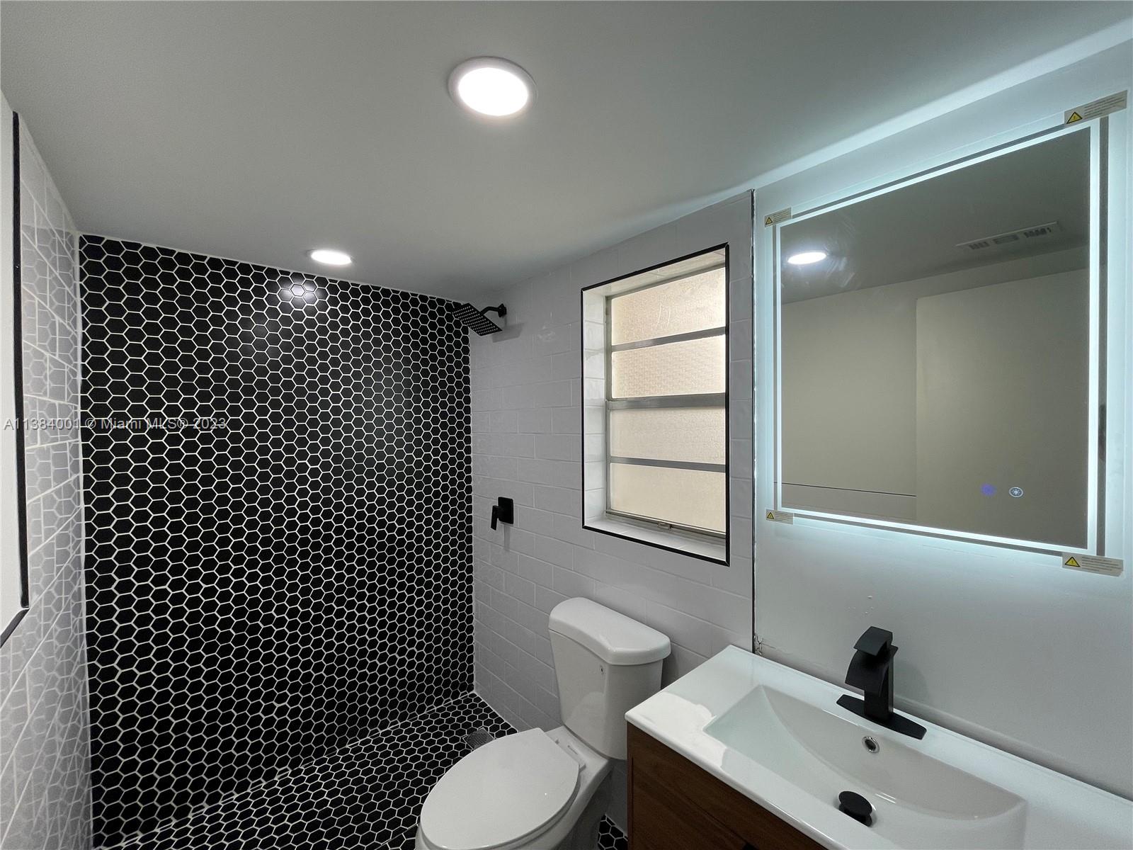 7765 Southwest 86th Street, Unit F2412 Miami, FL 33143 - Photo 24 of 53 a bathroom with a sink toilet and window