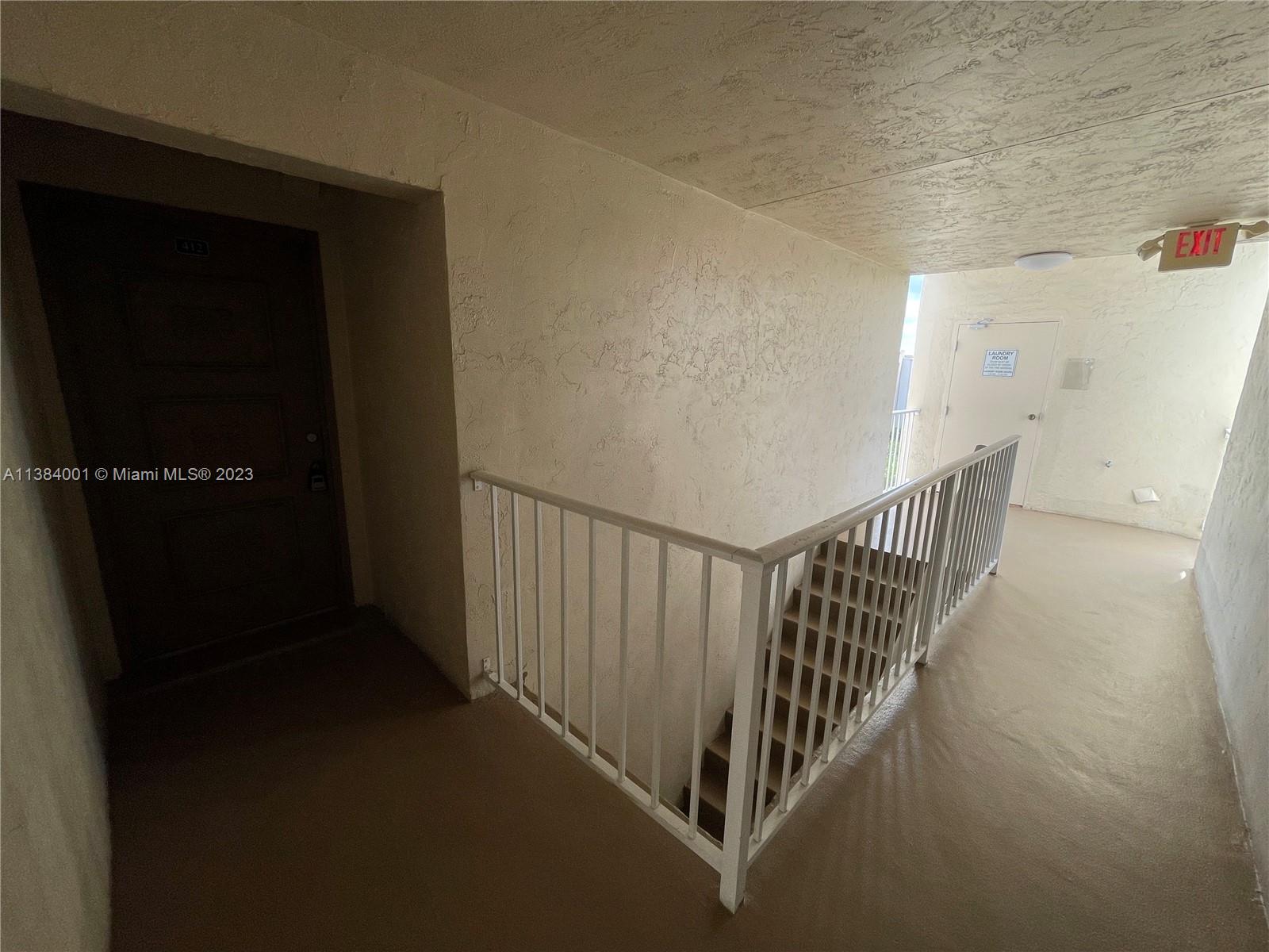 7765 Southwest 86th Street, Unit F2412 Miami, FL 33143 - Photo 40 of 53 a view of a hallway with stairs