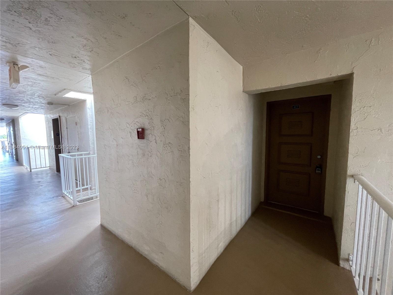 7765 Southwest 86th Street, Unit F2412 Miami, FL 33143 - Photo 42 of 53 a view of a hallway with wooden floor