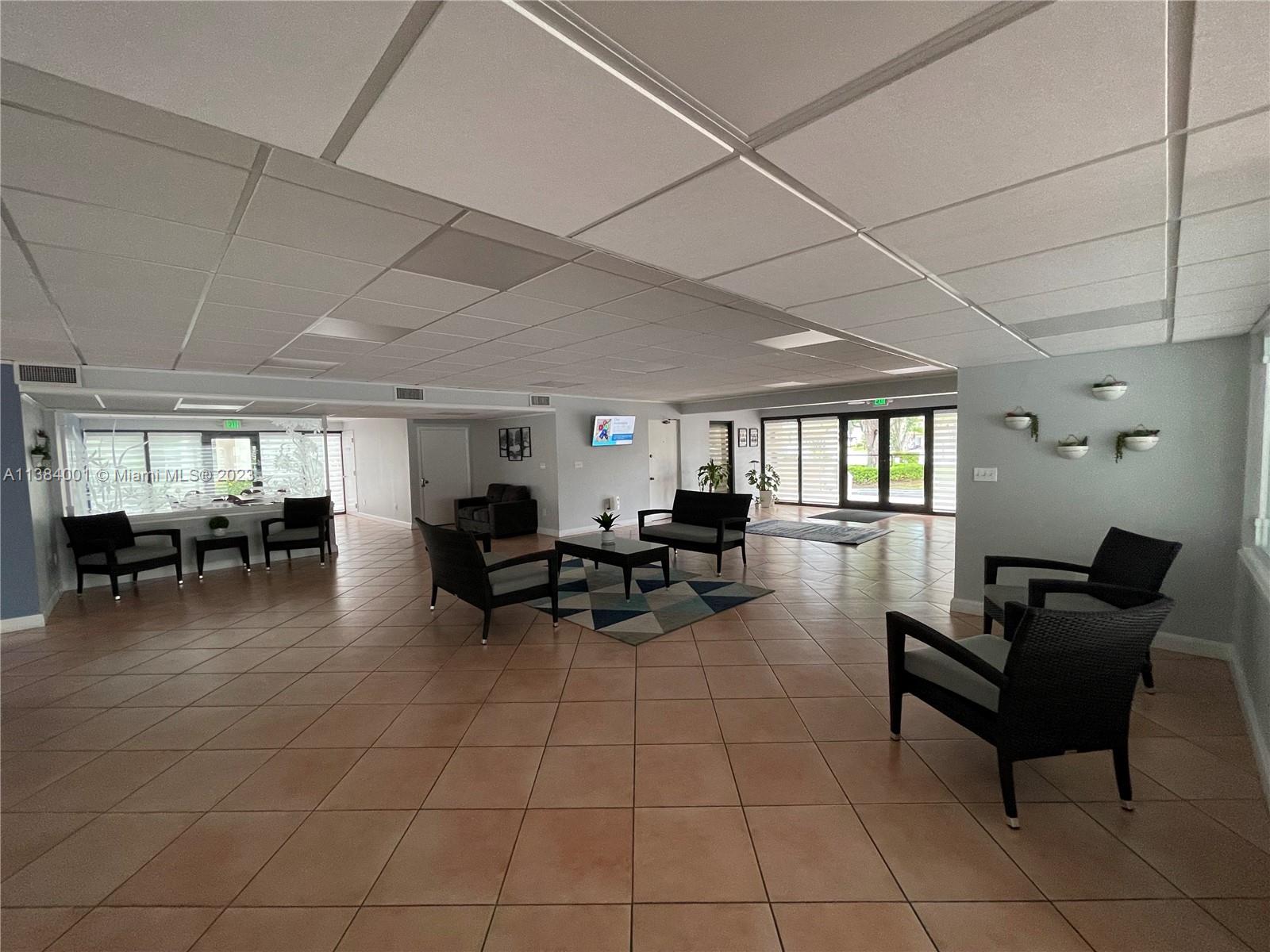 7765 Southwest 86th Street, Unit F2412 Miami, FL 33143 - Photo 52 of 53 a living room with furniture and a table