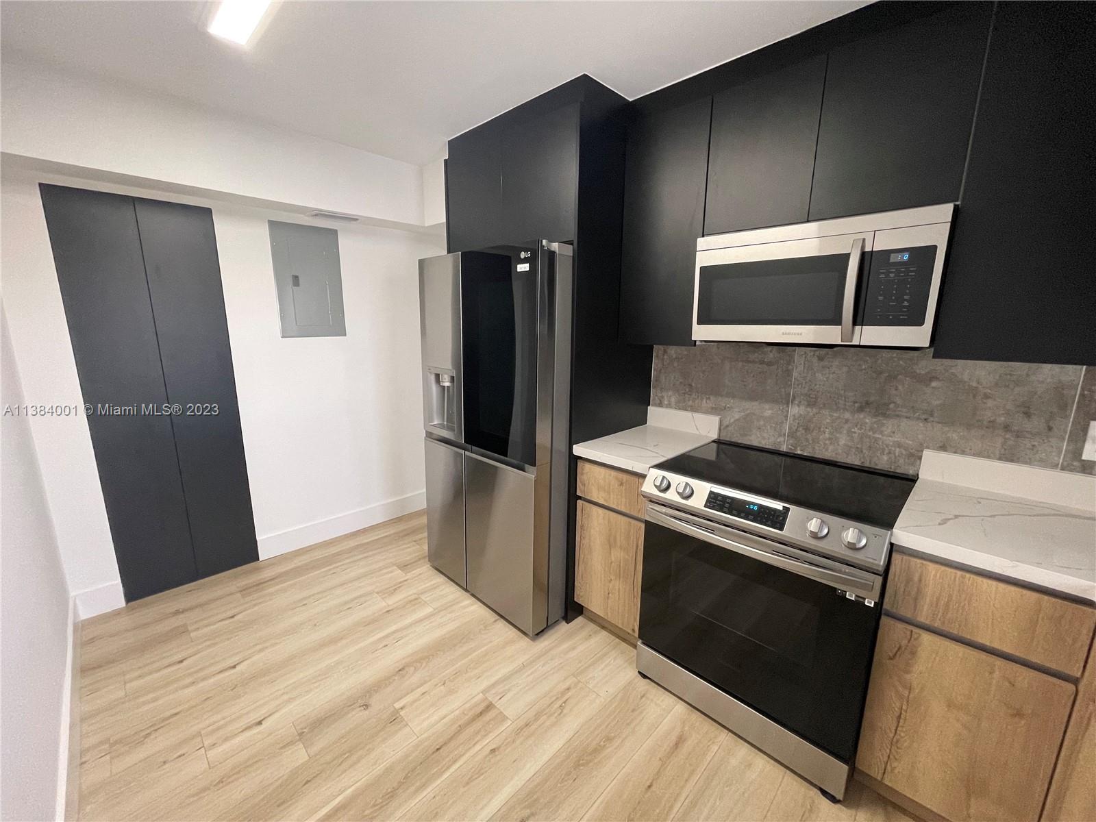 7765 Southwest 86th Street, Unit F2412 Miami, FL 33143 - Photo 7 of 53 a kitchen with a stove and a refrigerator