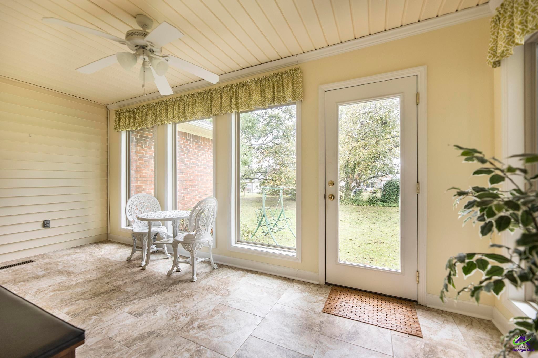 5731 School Road Macon, GA 31216 - Photo 26 of 33 Relax in the bright sunroom overlooking peaceful surroundings.
