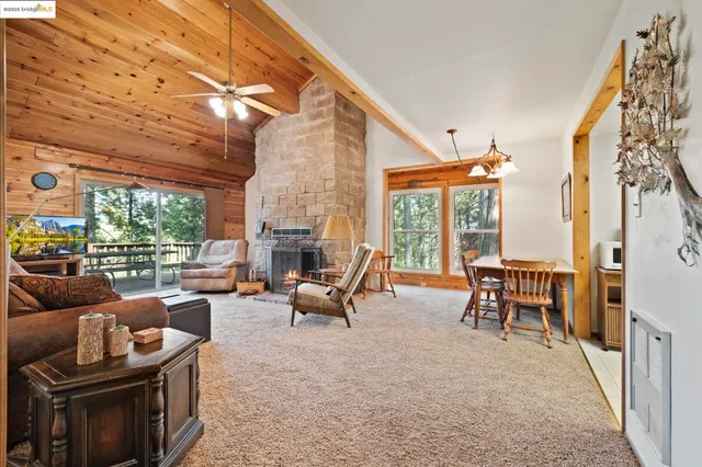 a living room with patio furniture and a floor to ceiling window