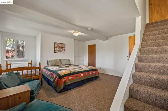 a bedroom with a bed and a couch