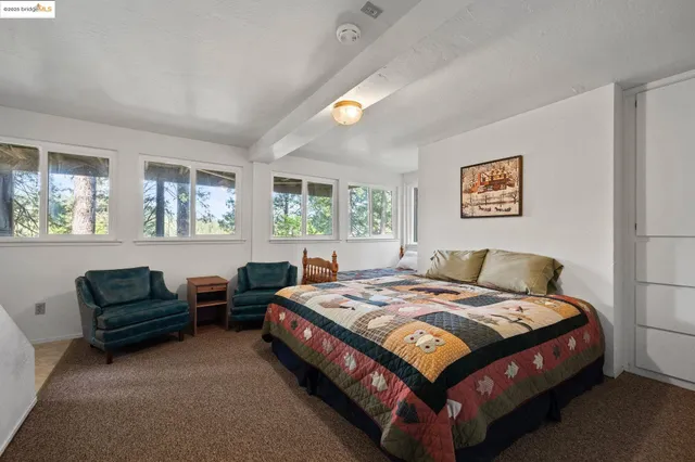 a bedroom with a bed couch and a window