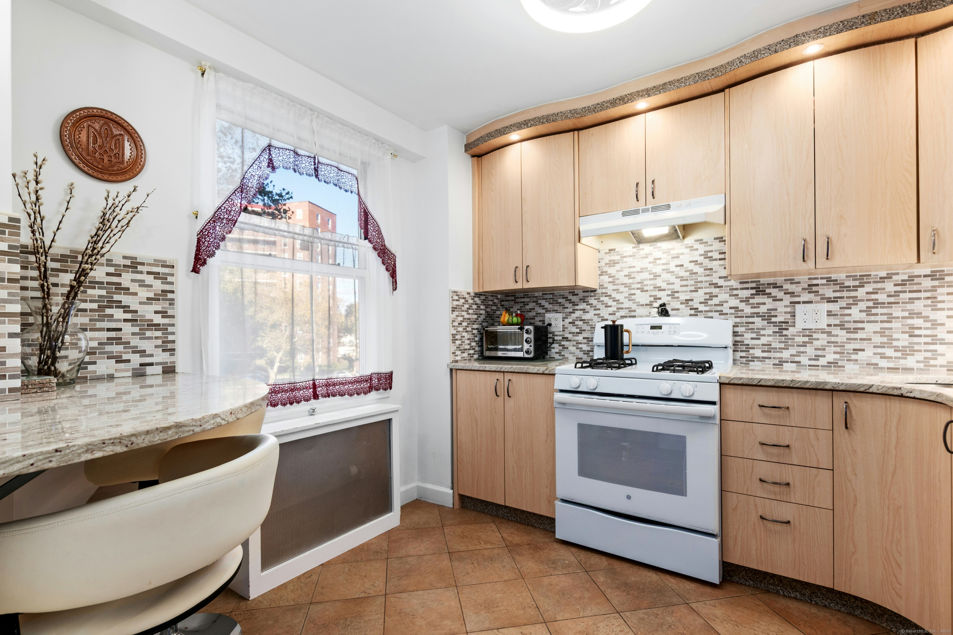71 Strawberry Hill Avenue, Unit 305 Stamford, CT 06902 - Photo 12 of 29 a kitchen with stainless steel appliances a sink window and cabinets