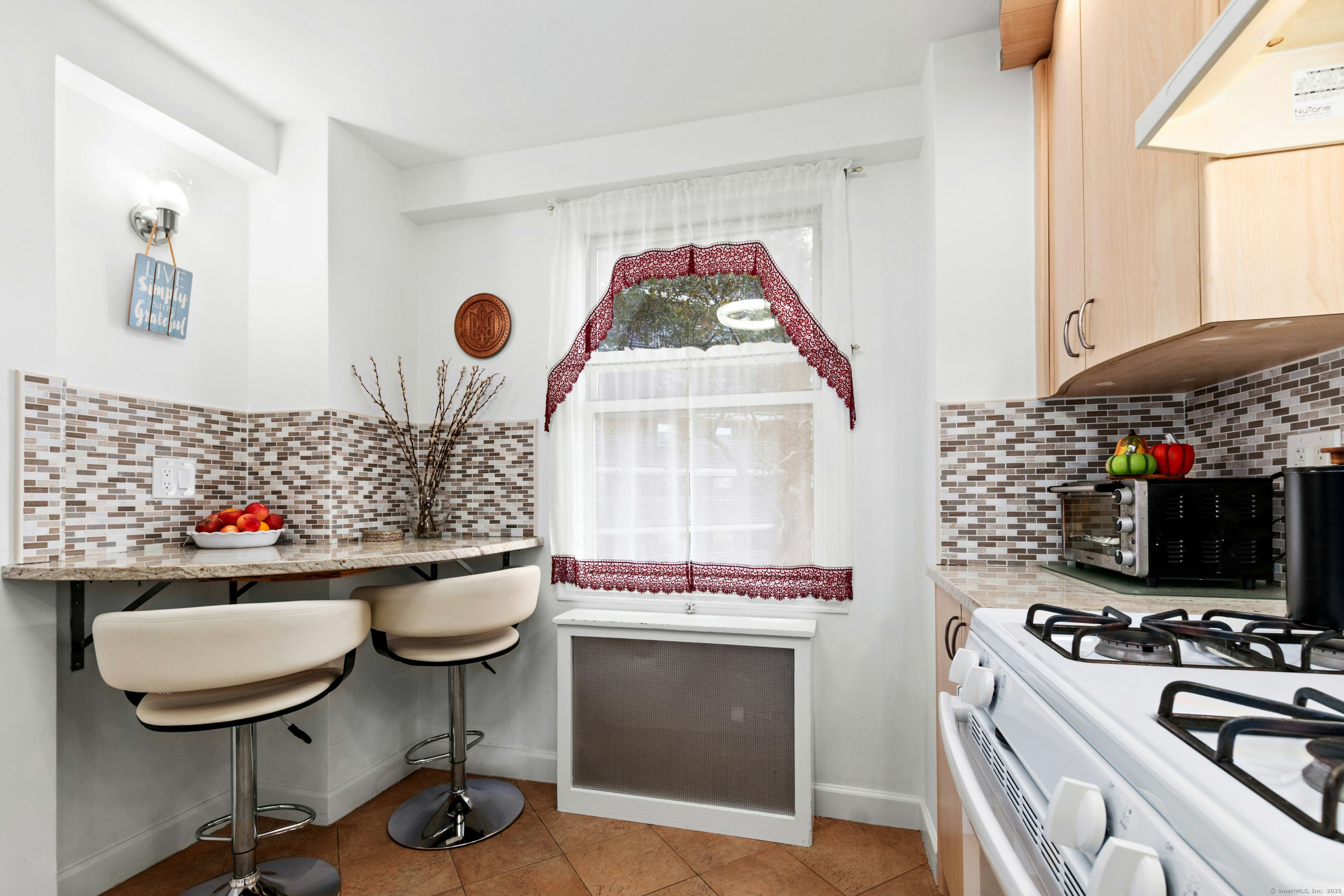 71 Strawberry Hill Avenue, Unit 305 Stamford, CT 06902 - Photo 13 of 29 a living room with furniture and a flat screen tv