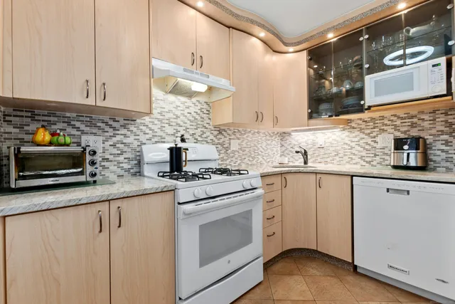 a kitchen with stainless steel appliances granite countertop a sink and cabinets