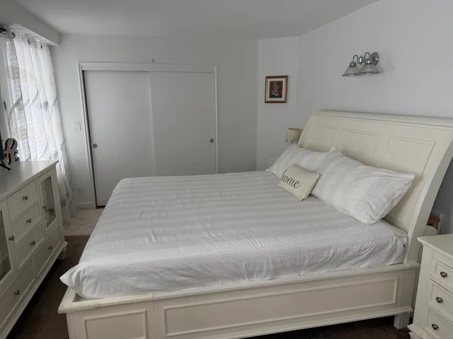 a bedroom with a bed and a dresser