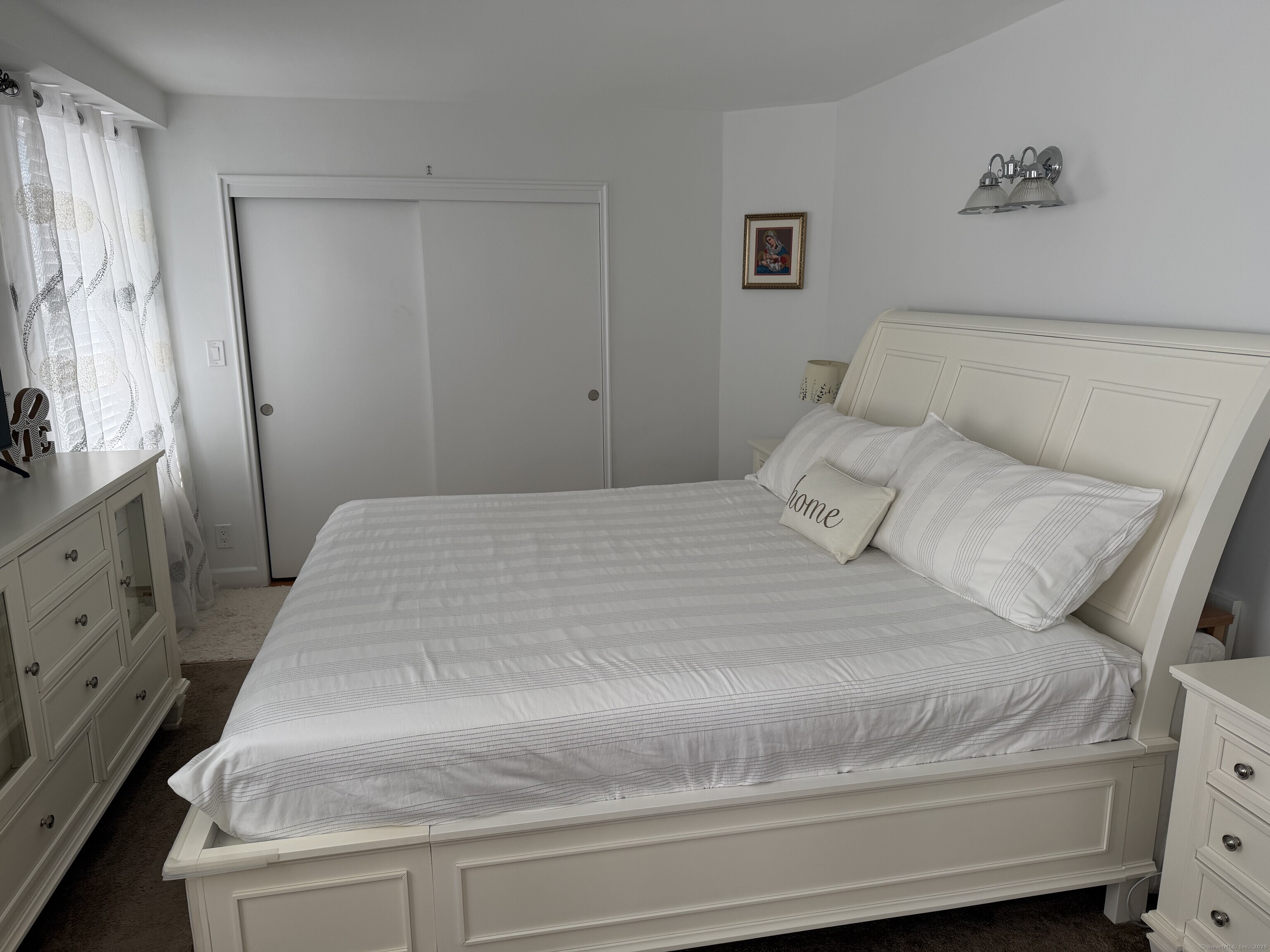 71 Strawberry Hill Avenue, Unit 305 Stamford, CT 06902 - Photo 16 of 29 a bedroom with a bed and a dresser