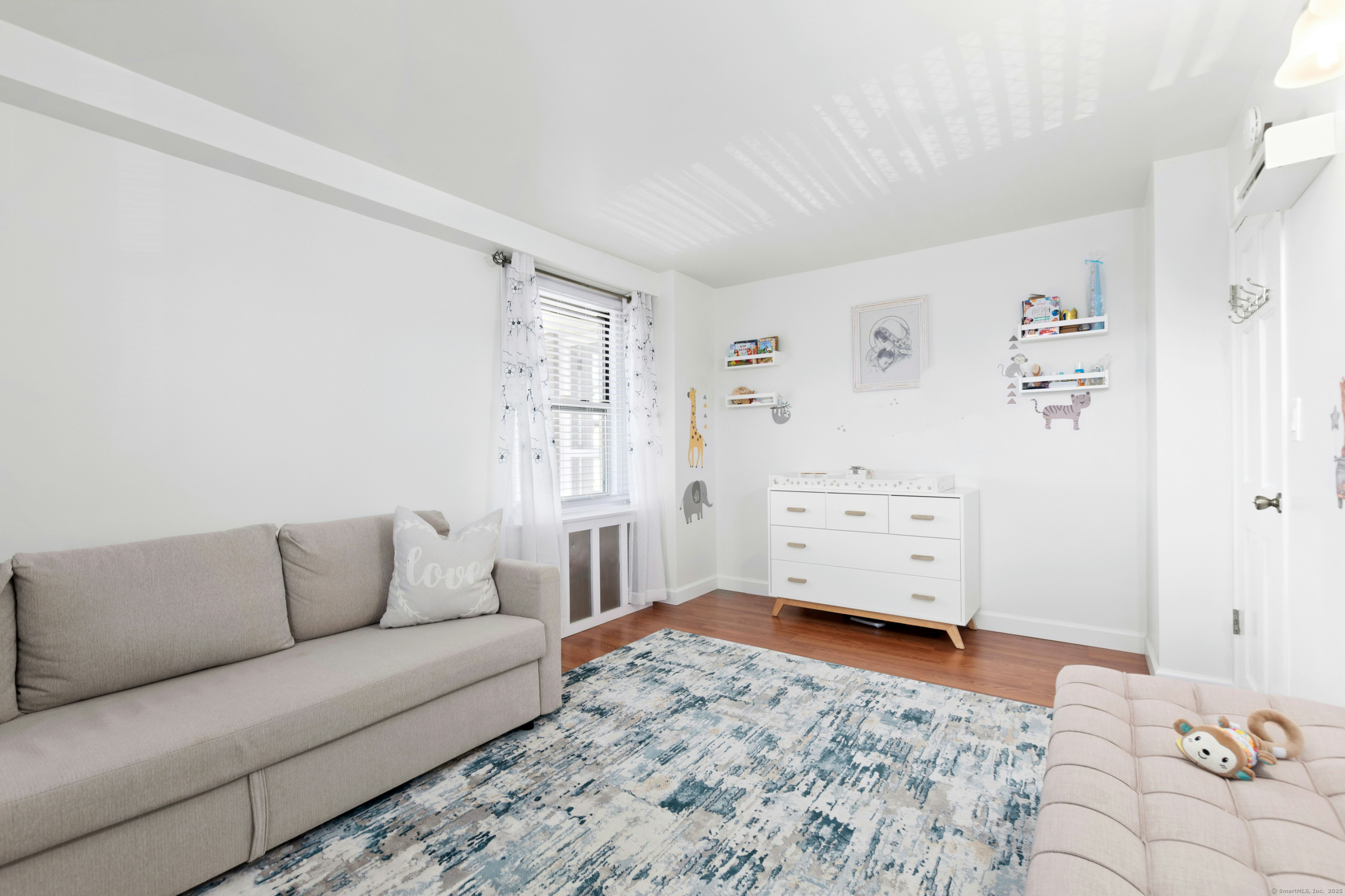 71 Strawberry Hill Avenue, Unit 305 Stamford, CT 06902 - Photo 19 of 29 a living room with furniture and dresser