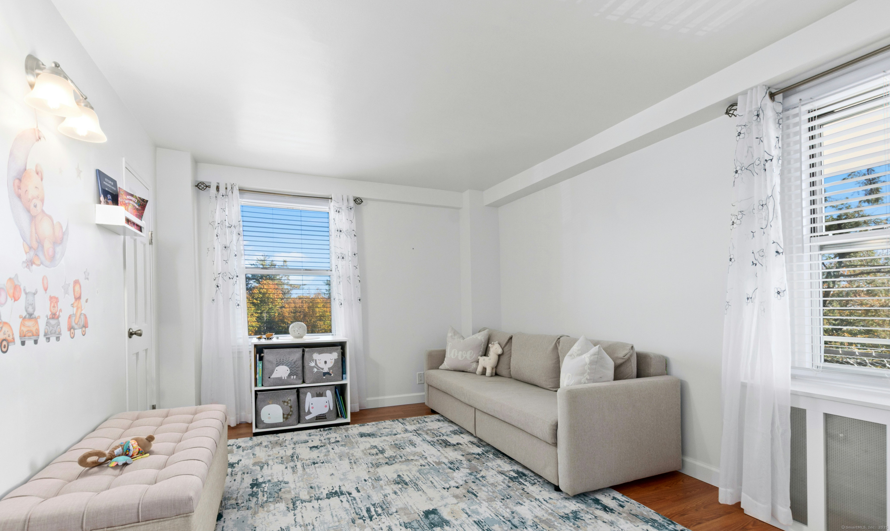 71 Strawberry Hill Avenue, Unit 305 Stamford, CT 06902 - Photo 20 of 29 a living room with furniture and a gate