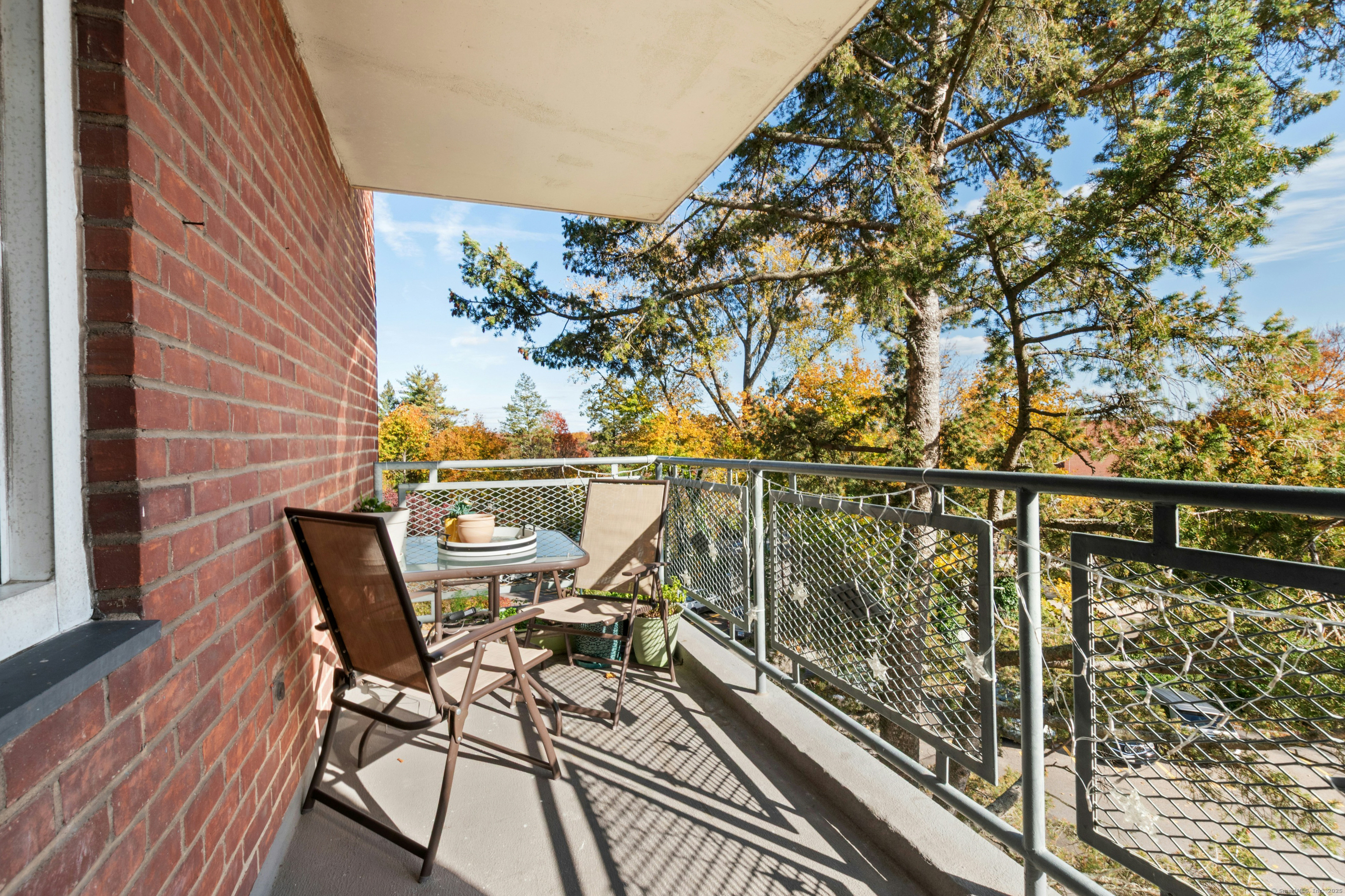 71 Strawberry Hill Avenue, Unit 305 Stamford, CT 06902 - Photo 24 of 29 a view of a balcony with chairs