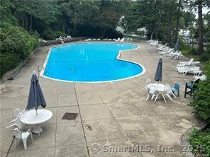 71 Strawberry Hill Avenue, Unit 305 Stamford, CT 06902 - Photo 28 of 29 a backyard of a house with table and chairs