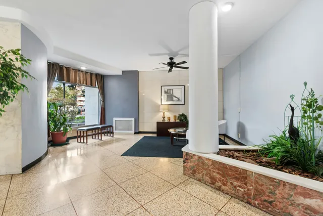 a living room with furniture and a potted plant