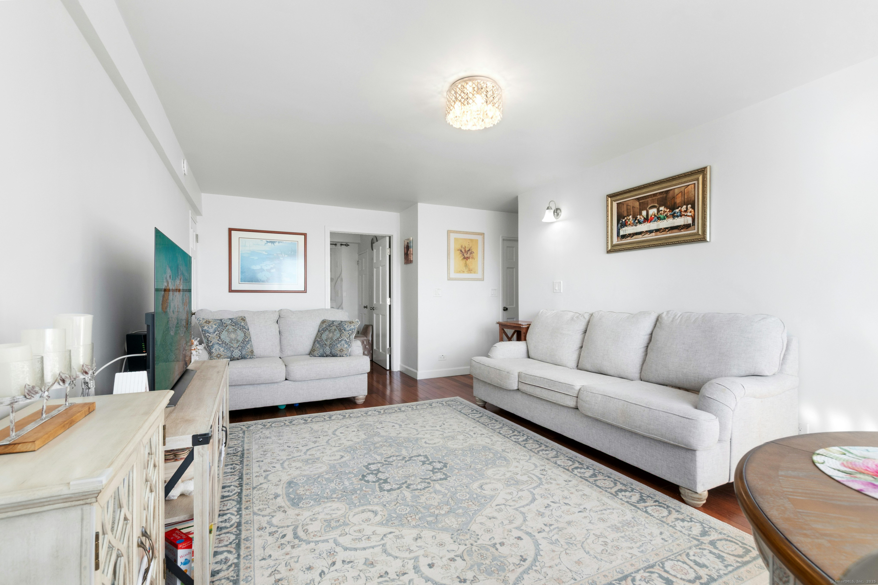 71 Strawberry Hill Avenue, Unit 305 Stamford, CT 06902 - Photo 8 of 29 a living room with furniture and a couch