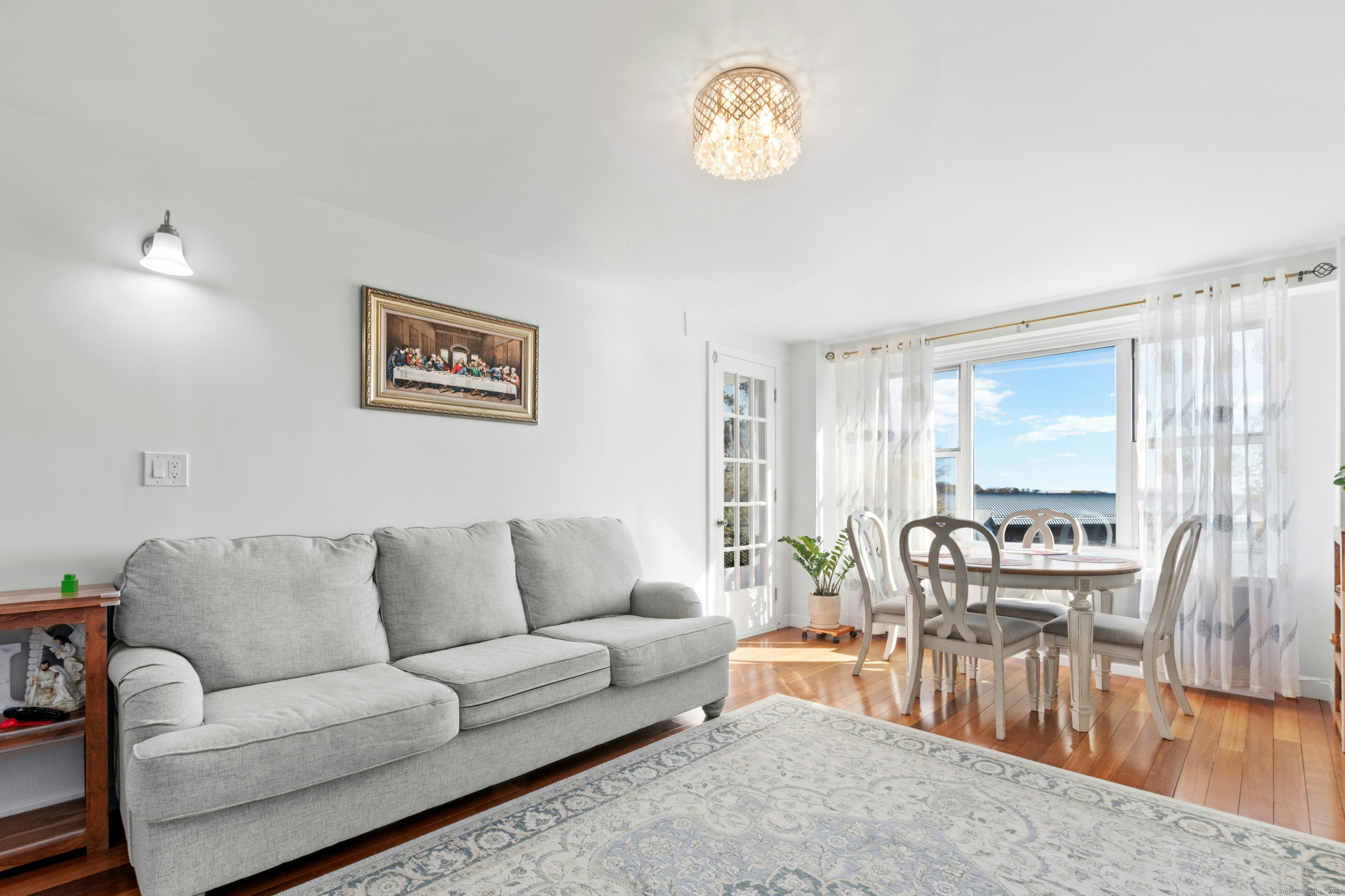 71 Strawberry Hill Avenue, Unit 305 Stamford, CT 06902 - Photo 9 of 29 a living room with furniture and a large window
