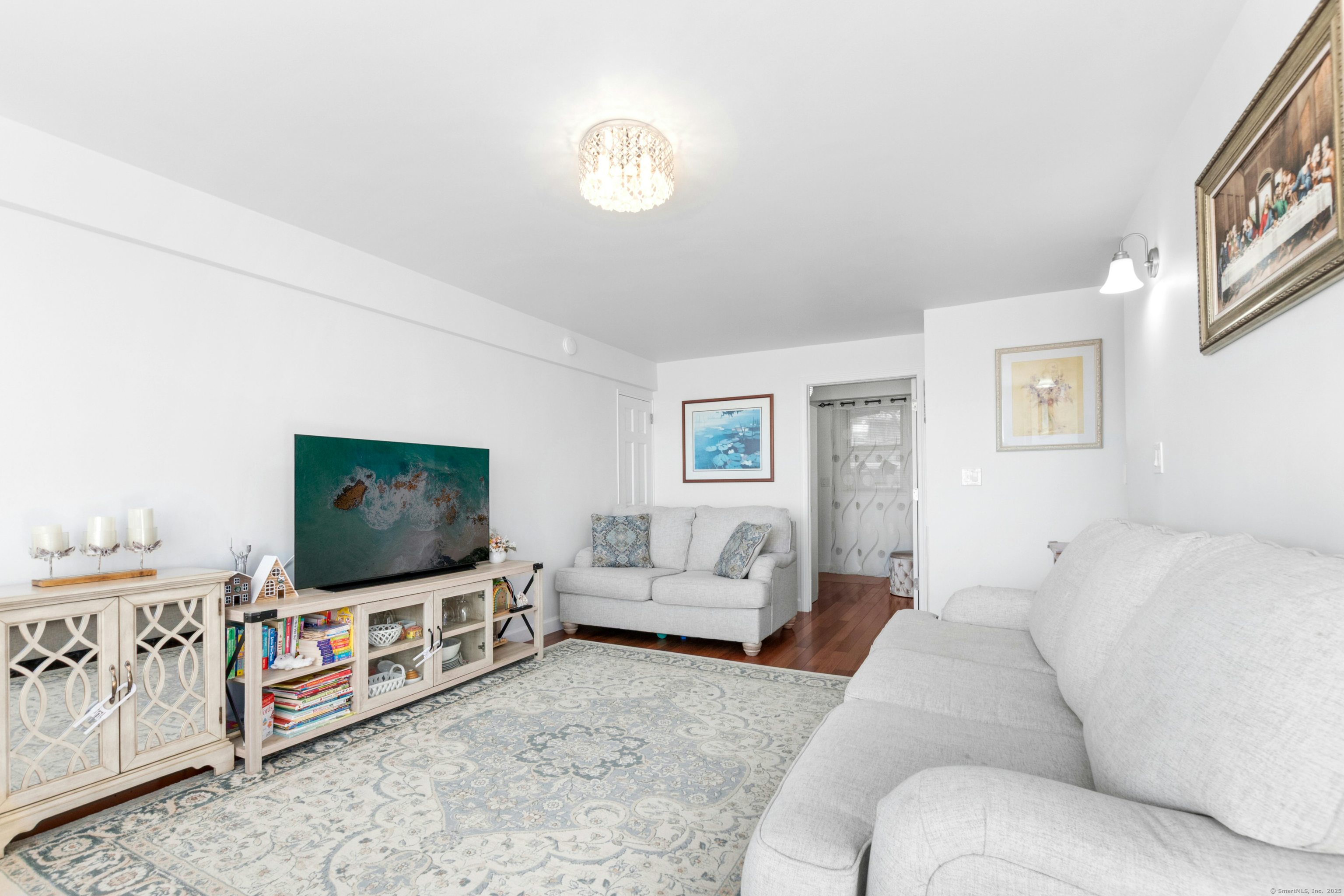 71 Strawberry Hill Avenue, Unit 305 Stamford, CT 06902 - Photo 10 of 29 a living room with furniture and a flat screen tv