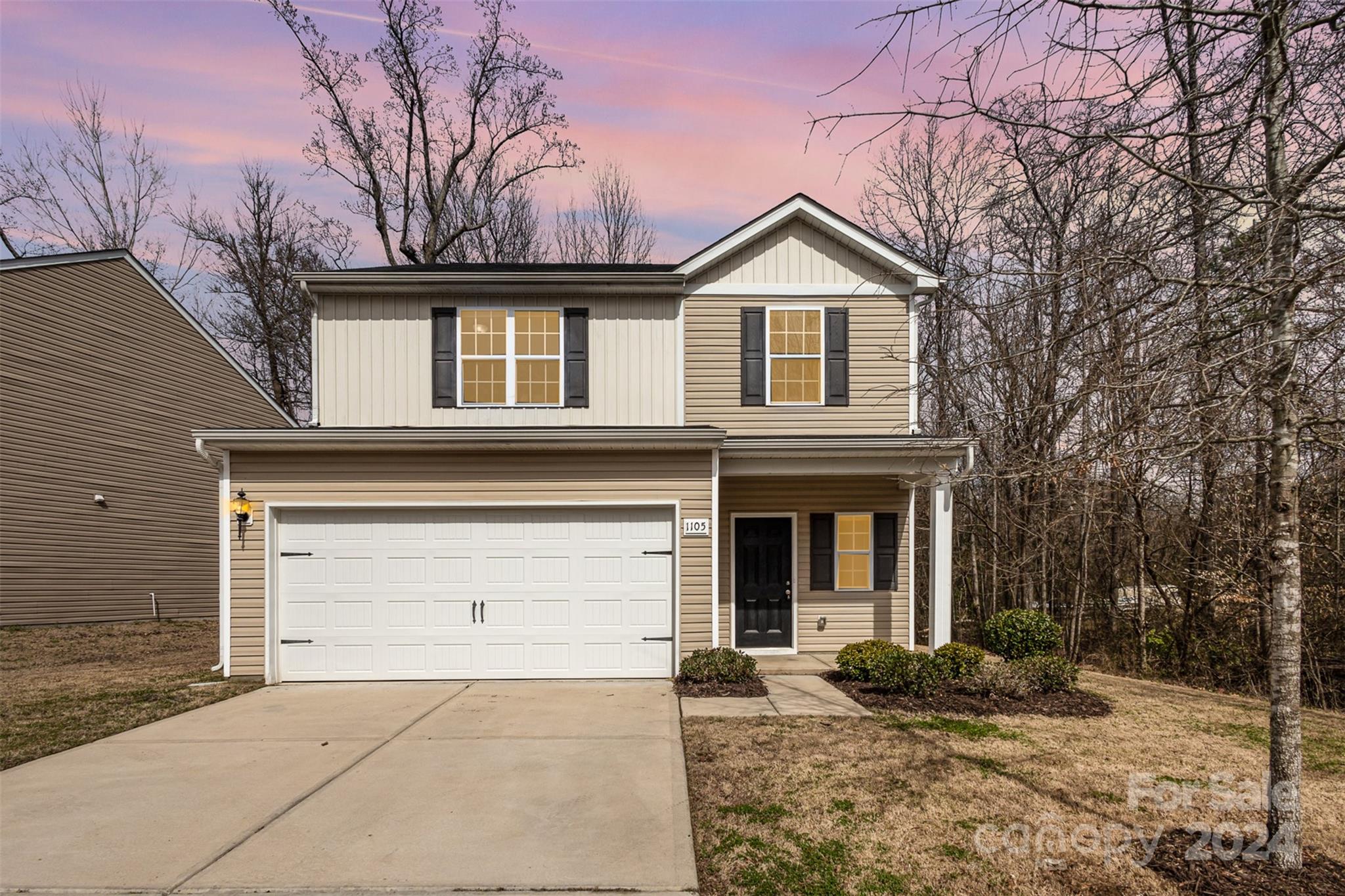1105 Rook Road Charlotte, NC 28216 - Photo 1 of 14 a front view of a house with a yard and garage