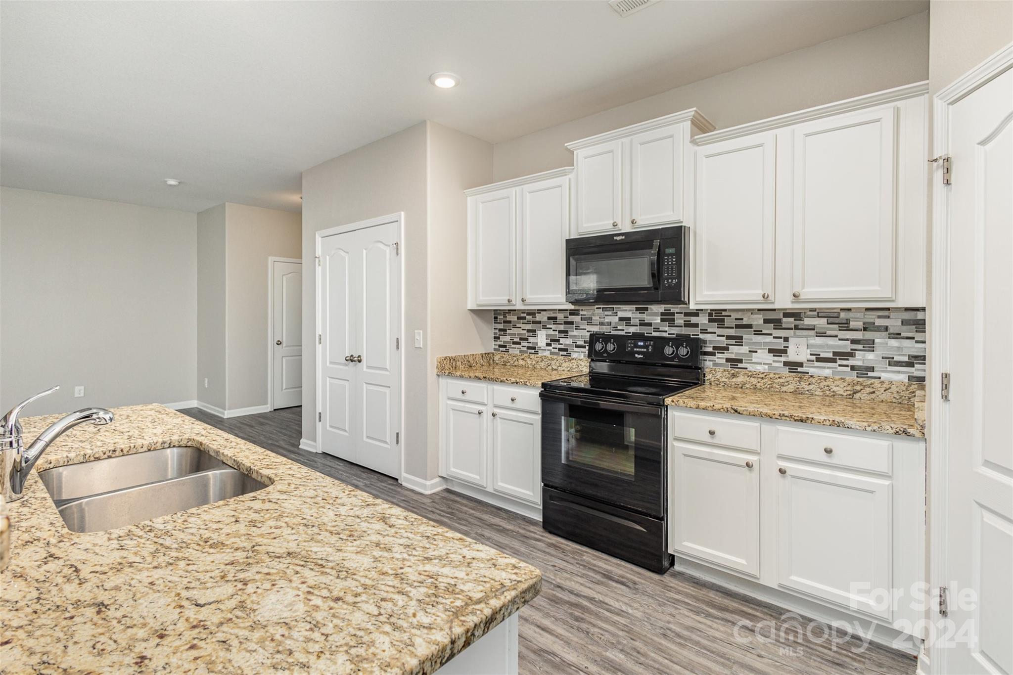 1105 Rook Road Charlotte, NC 28216 - Photo 4 of 14 a kitchen with granite countertop cabinets and steel stainless steel appliances