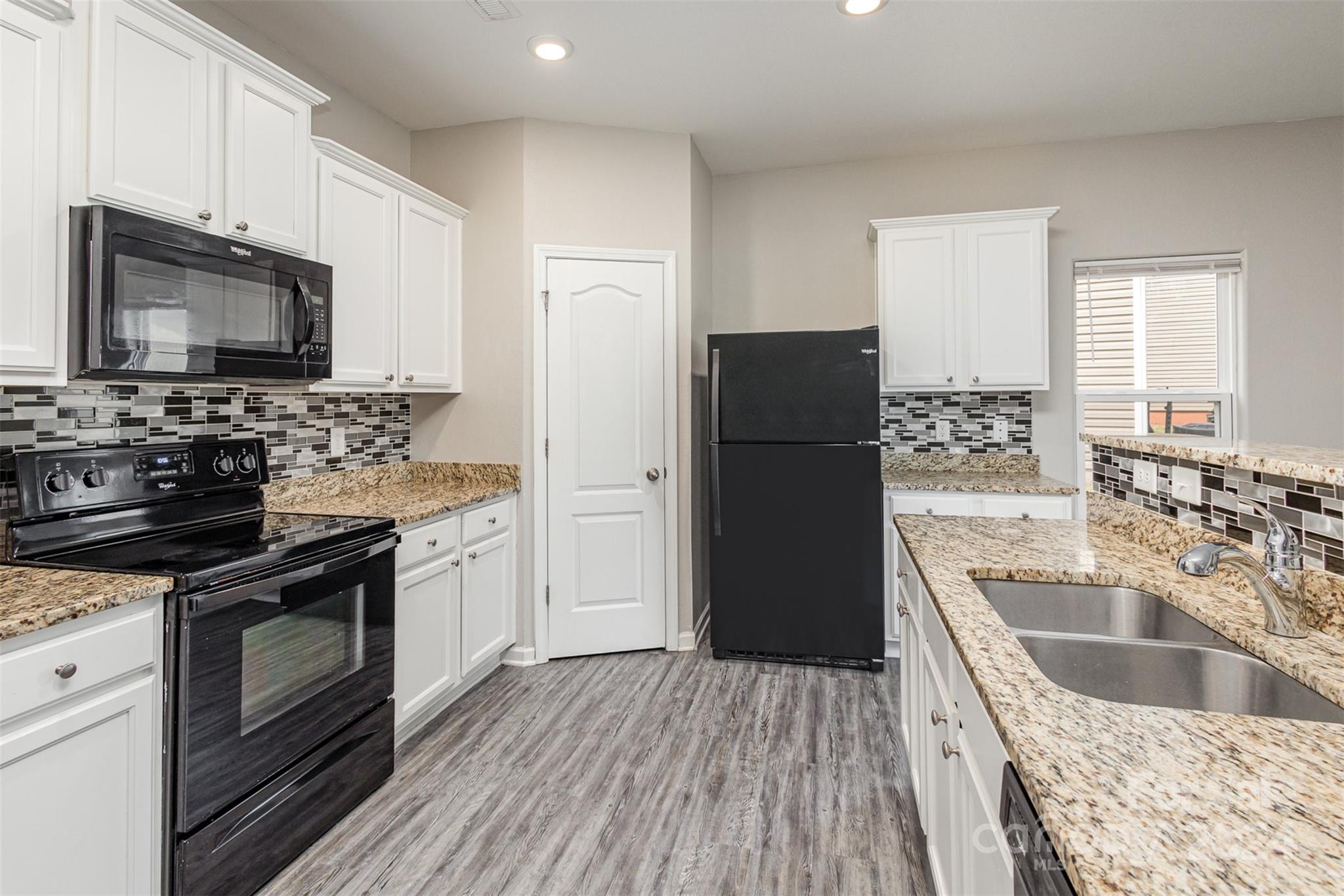 1105 Rook Road Charlotte, NC 28216 - Photo 5 of 14 a kitchen with a sink stove and refrigerator