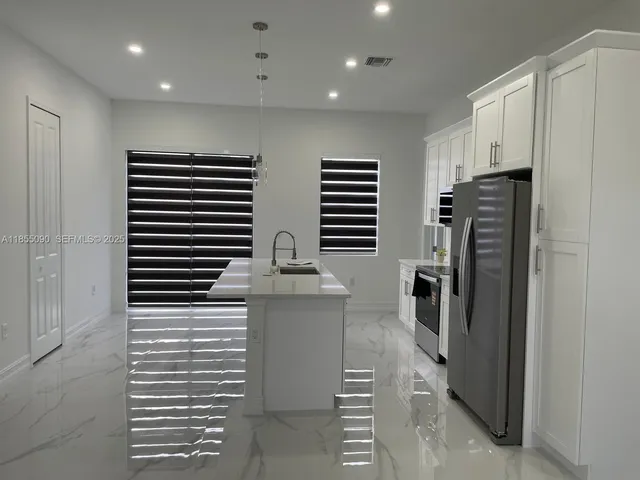 a kitchen with stainless steel appliances a refrigerator and a stove