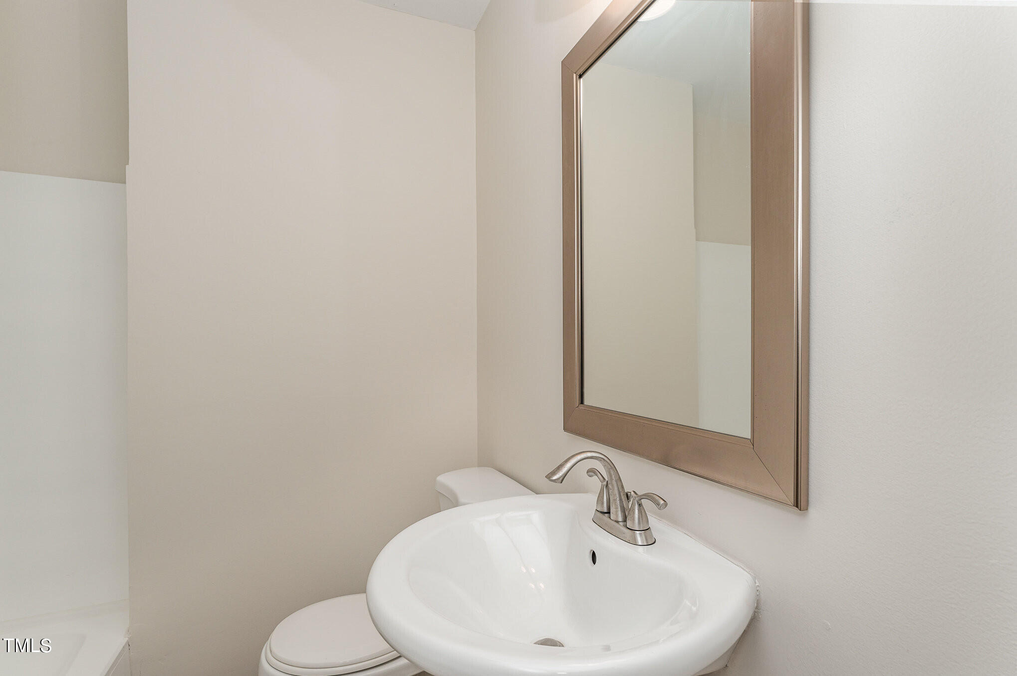3528 Brentwood Road Raleigh, NC 27604 - Photo 8 of 17 a bathroom with a sink a toilet and mirror