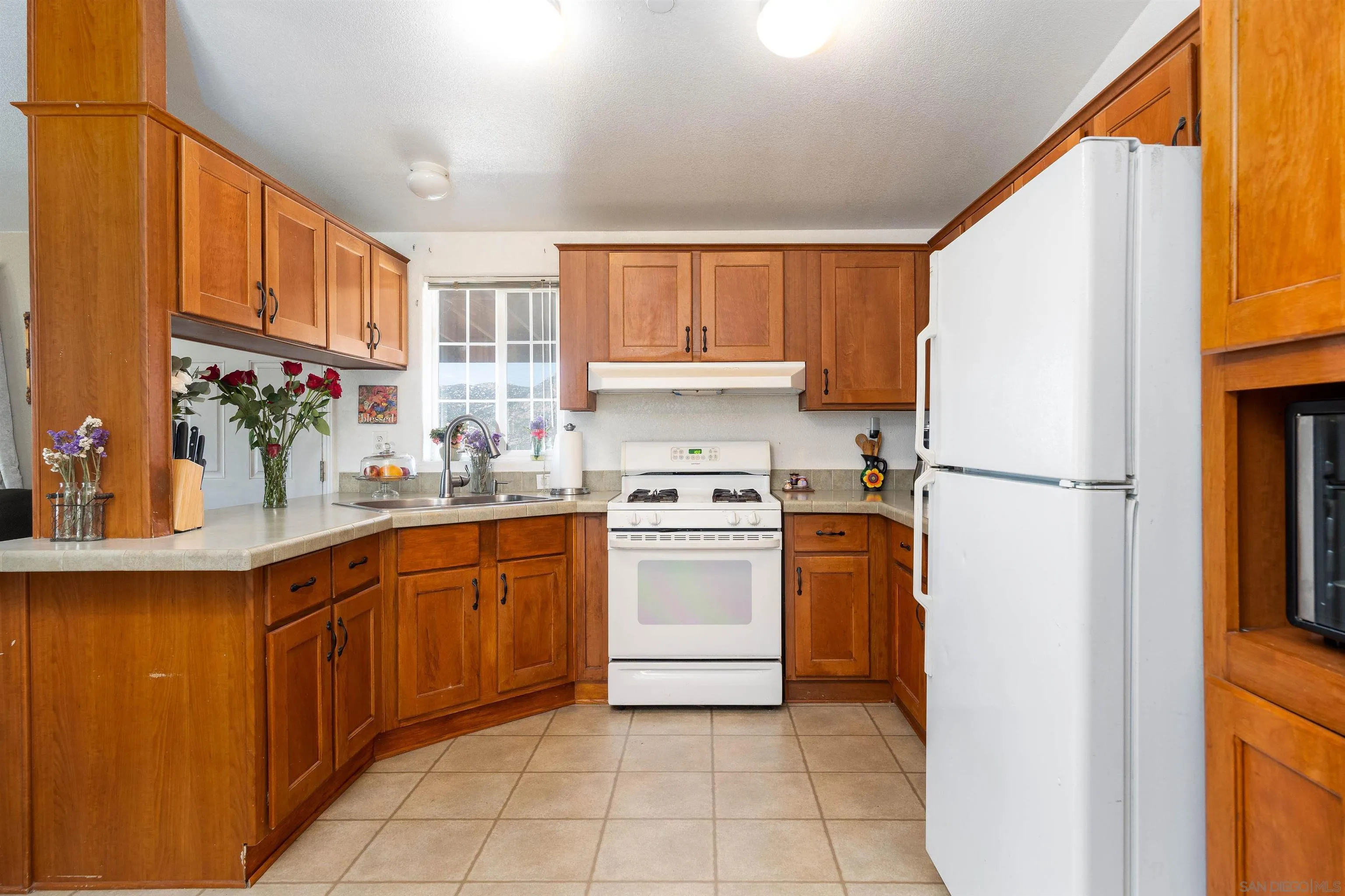 23744 Old Ranch Road Alpine, CA 91901 - Photo 3 of 17 a kitchen with stainless steel appliances granite countertop a refrigerator sink and cabinets