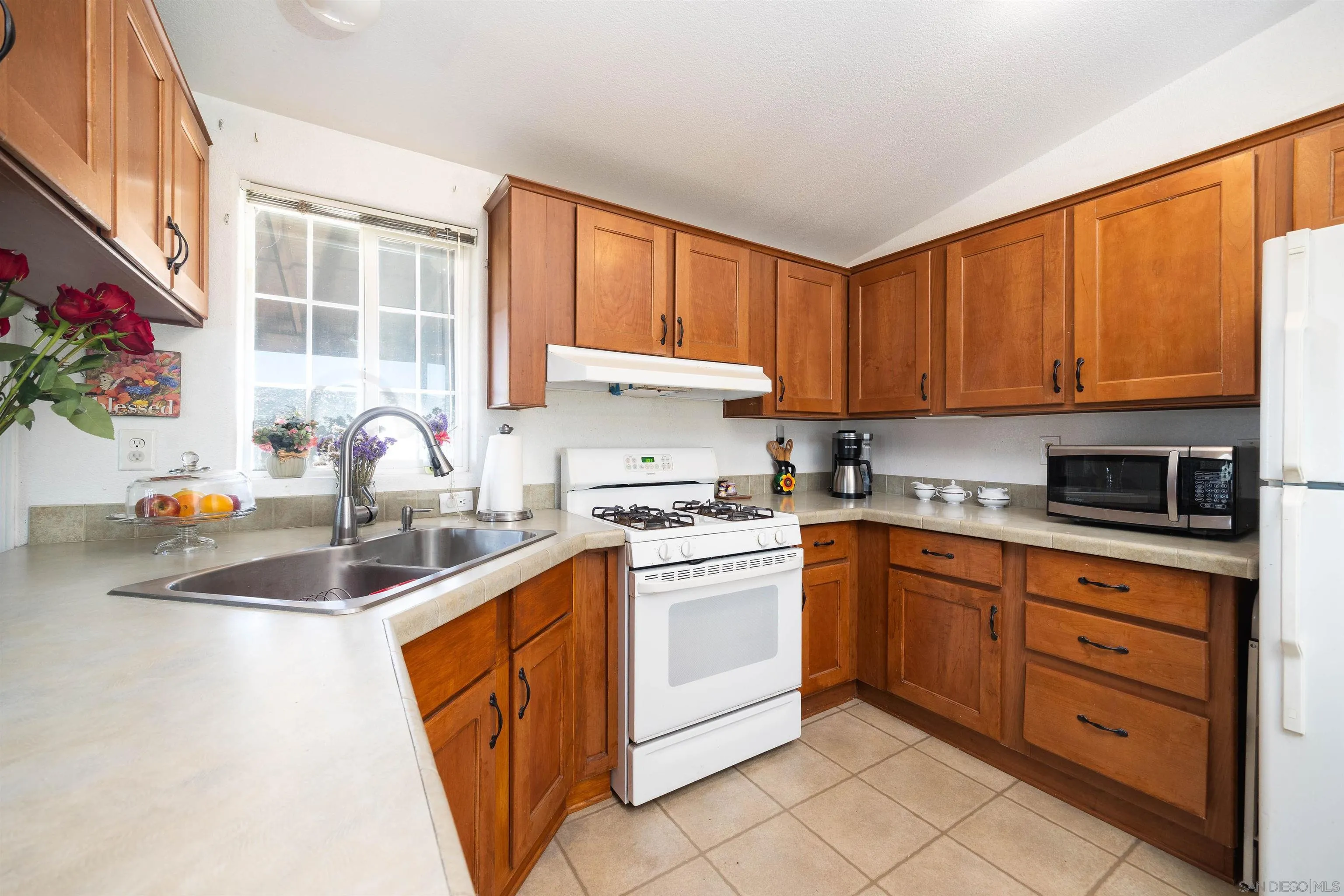 23744 Old Ranch Road Alpine, CA 91901 - Photo 4 of 17 a kitchen with stainless steel appliances granite countertop a sink stove and cabinets