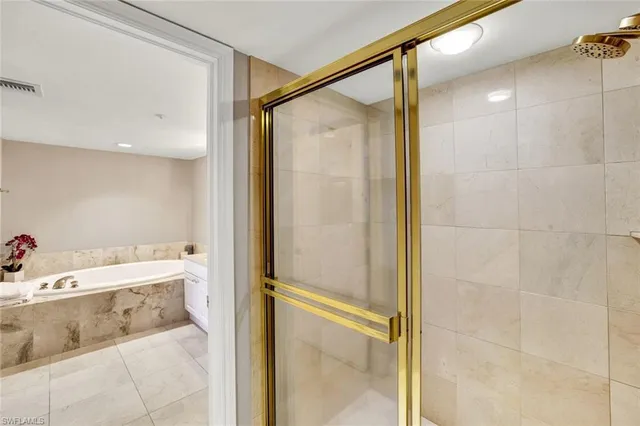 a bathroom with a tub and a shower
