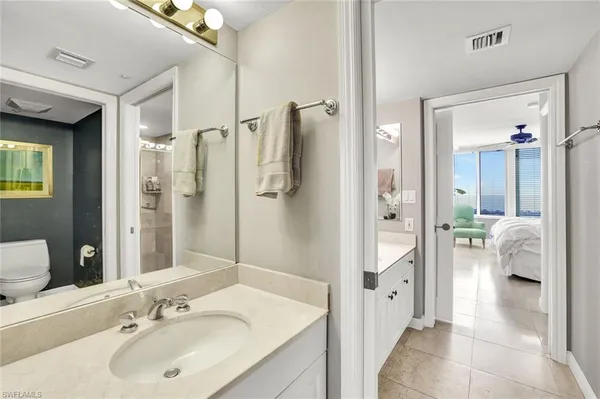 a en suite bathroom with a sink shower and a mirror
