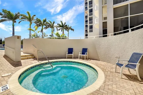 a small swimming pool with a lounge chair