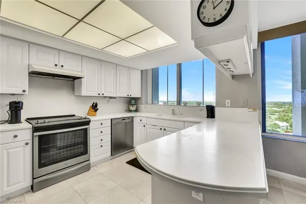 a kitchen with a stove a sink and a refrigerator