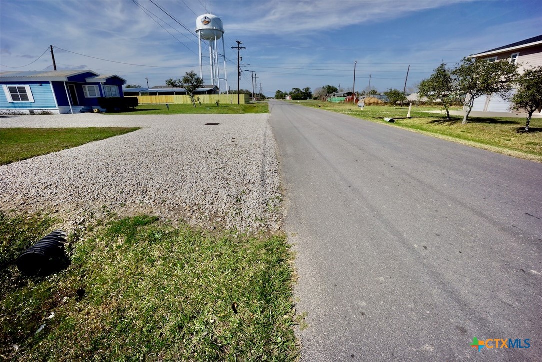 513 16th Street Port O'Connor, TX 77982 - Photo 11 of 35 a view of a swimming pool and a yard in the background