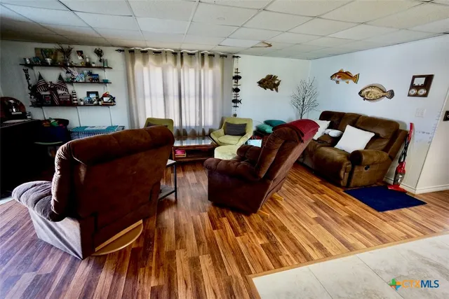 a living room with furniture fireplace and a large window