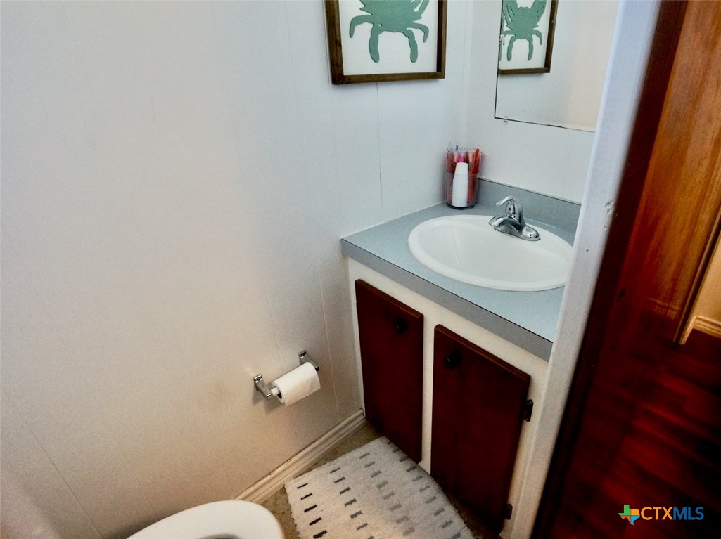 513 16th Street Port O'Connor, TX 77982 - Photo 17 of 35 a bathroom with a sink and a mirror