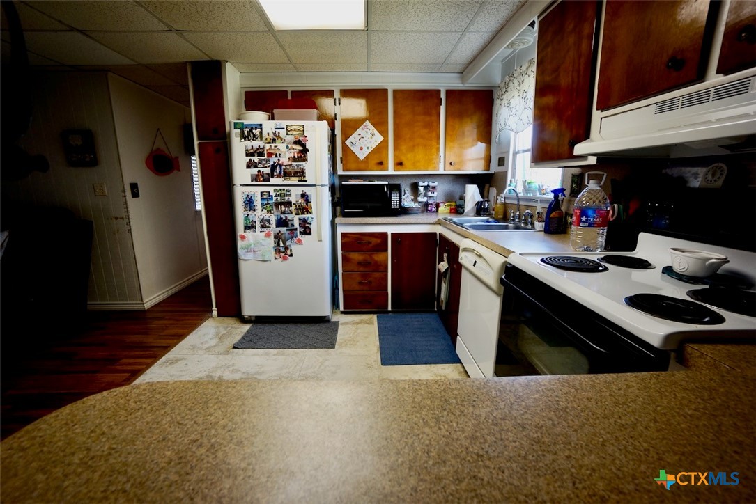 513 16th Street Port O'Connor, TX 77982 - Photo 20 of 35 a kitchen with stainless steel appliances granite countertop a refrigerator and a stove