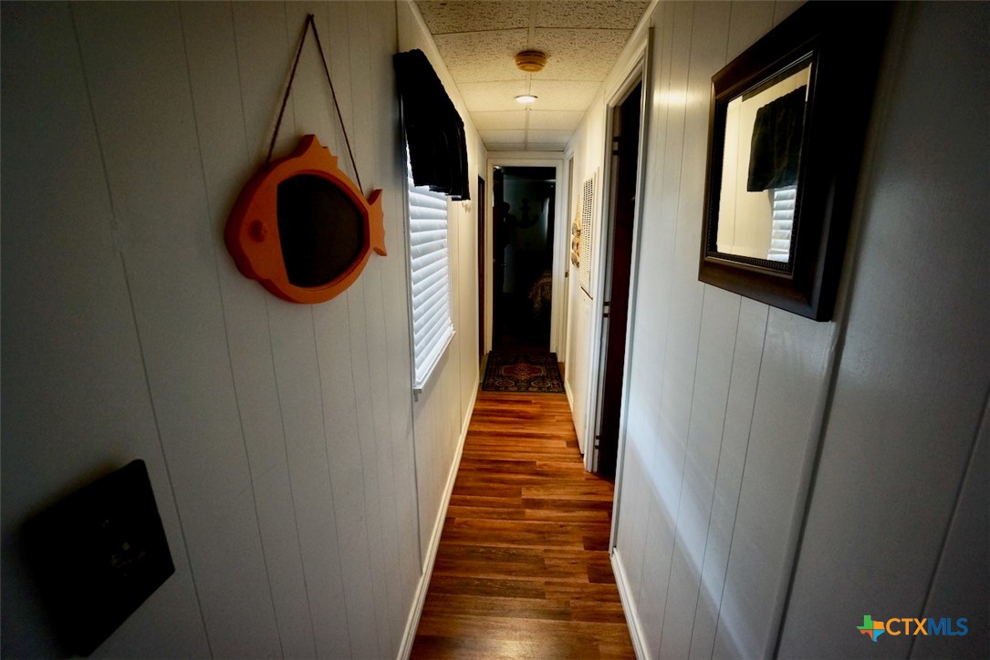 513 16th Street Port O'Connor, TX 77982 - Photo 22 of 35 a view of a hallway with wooden floor and staircase